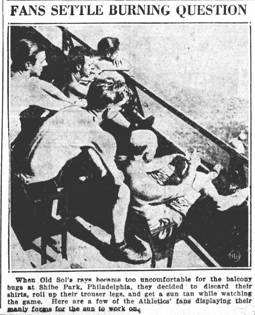 Photograph headed Fans Settle Burning Question, showing a cluster of shirtless men leaning over a balcony railing at Shibe Park in Philadelphia, caps on, shirts off, watching a ball game below. The caption explains that when Old Sol's rays became too uncomfortable for the balcony bugs at Shibe Park, they decided to discard their shirts, roll up their trouser legs, and get a sun tan while watching the game.