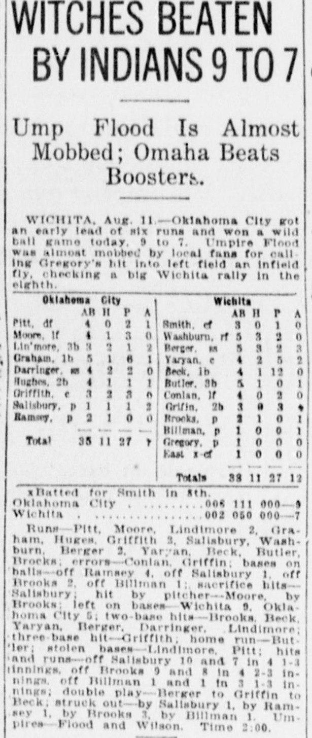 Game story headed Witches Beaten by Indians 9 to 7, with the subhead Ump Flood Is Almost Mobbed, Omaha Beats Boosters. The report from Wichita says Oklahoma City got an early lead of six runs and won a wild ball game, and that Umpire Flood was almost mobbed by local fans for calling Gregory's hit into left field an infield fly, checking a big Wichita rally in the eighth. Full box scores for Oklahoma City and Wichita follow with a long summary ending Umpires Flood and Wilson, time 2:00.